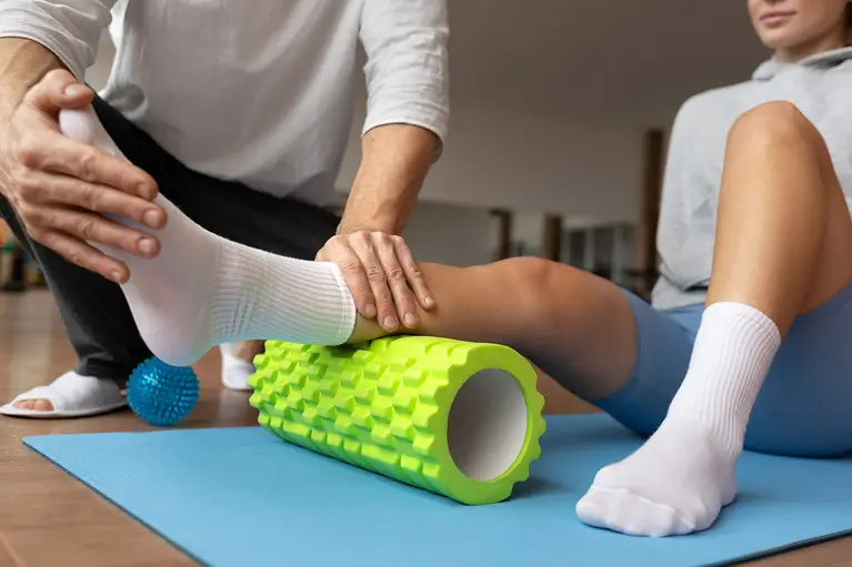 patient doing physical rehabilitation helped by therapists